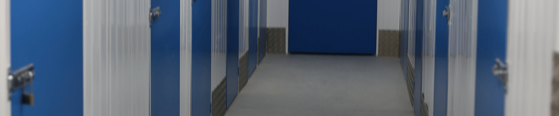 Corridor of blue storage unit doors inside Storage Factory Salisbury