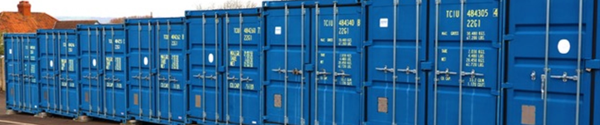 A row of blue storage containers at Storage Factory Glastonbury